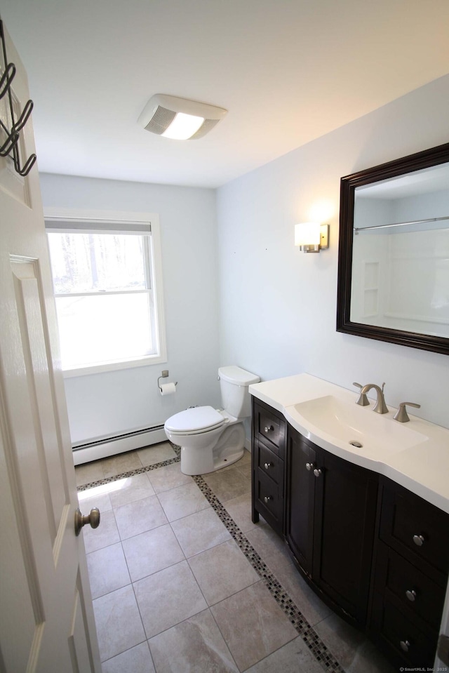 bathroom featuring vanity, tile patterned floors, a baseboard heating unit, and toilet