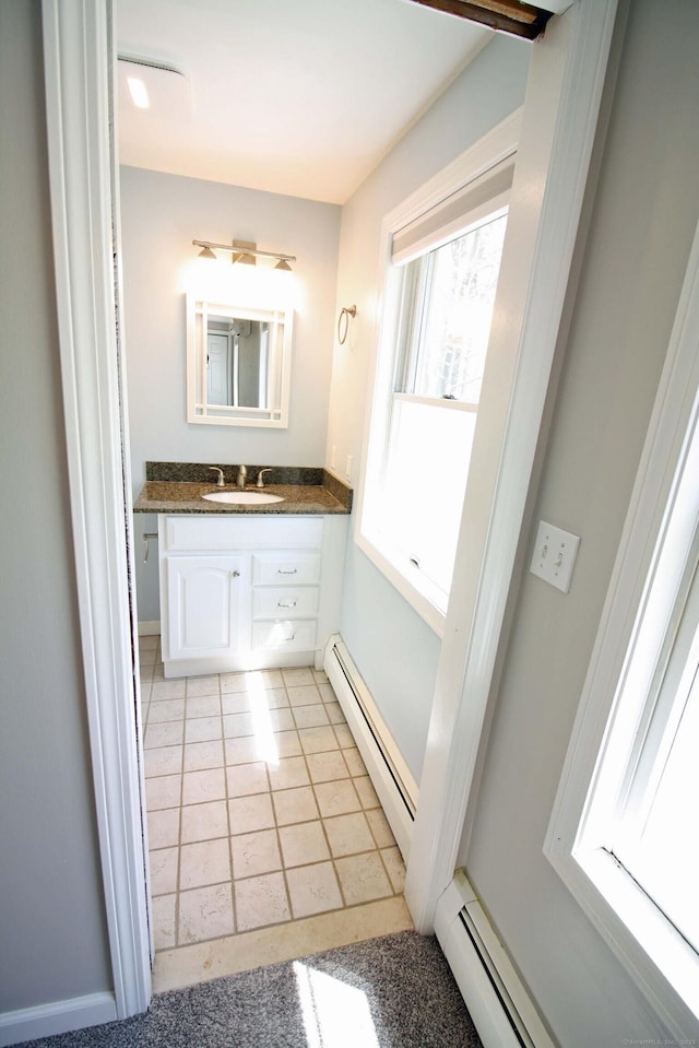 bathroom featuring vanity, a baseboard radiator, and tile patterned flooring