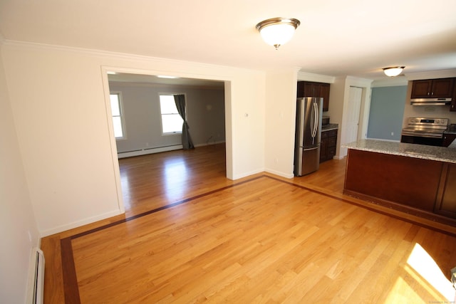 kitchen with appliances with stainless steel finishes, baseboard heating, under cabinet range hood, and light wood-type flooring