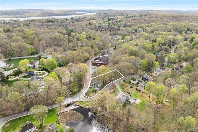 drone / aerial view featuring a view of trees