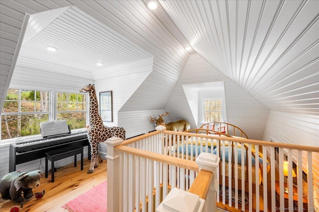 additional living space with wood ceiling, wood finished floors, vaulted ceiling, and a healthy amount of sunlight