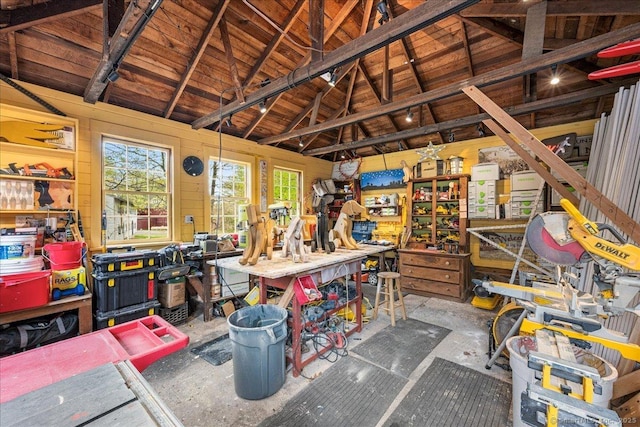 miscellaneous room with unfinished concrete flooring, vaulted ceiling, a workshop area, and wooden ceiling