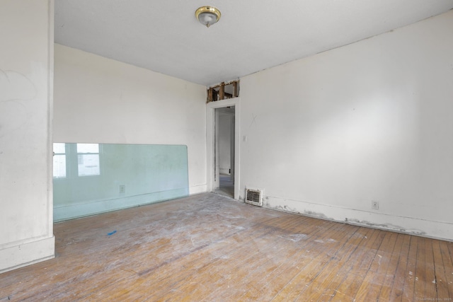 empty room with visible vents and wood-type flooring
