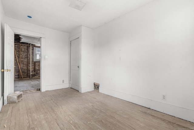 unfurnished room with wood finished floors