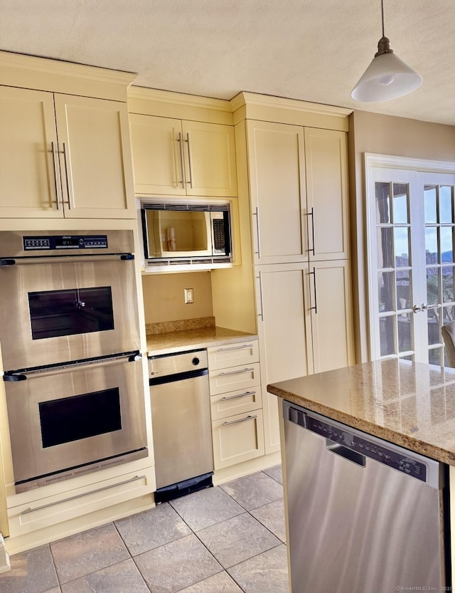 1 Gold St Unit 17De, Hartford, CT 06103 - kitchen with appliances with stainless steel finishes, cream cabinets, light stone countertops, hanging light fixtures, and a textured ceiling