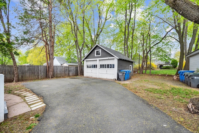 detached garage featuring fence