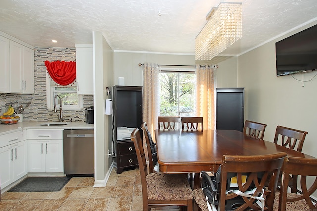 dining room featuring ornamental molding, a textured ceiling, and a chandelier