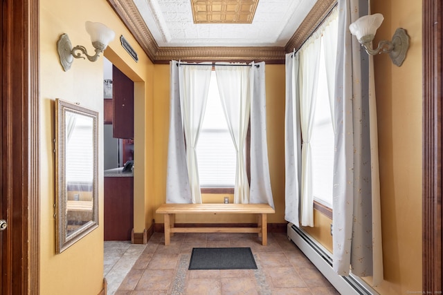 interior space featuring baseboards, an ornate ceiling, and a baseboard radiator