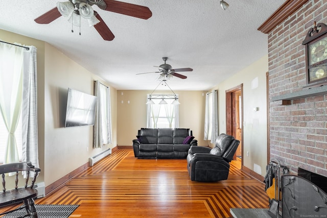 living area featuring a textured ceiling, a baseboard radiator, baseboards, light wood-type flooring, and a ceiling fan