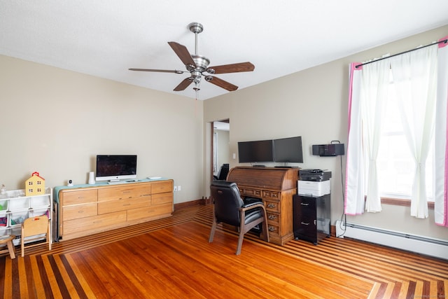 home office featuring a baseboard radiator, ceiling fan, and wood finished floors