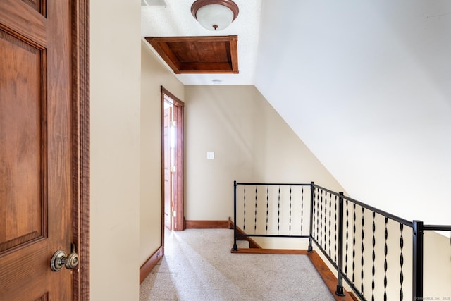 hall with an upstairs landing and baseboards