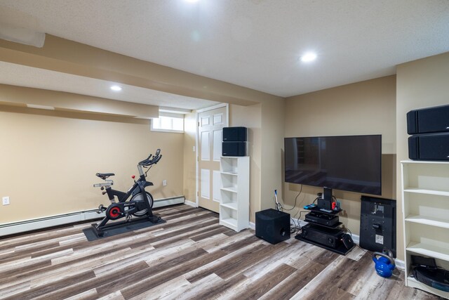 workout area featuring recessed lighting, wood finished floors, and baseboards