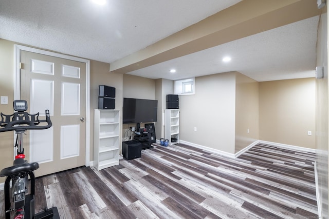 workout room featuring recessed lighting, wood finished floors, and baseboards