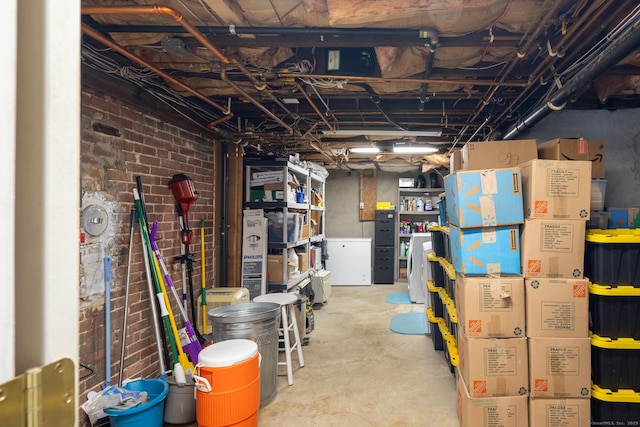unfinished below grade area featuring brick wall