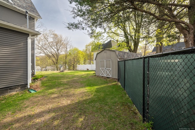 view of yard with an outdoor structure, a shed, and fence