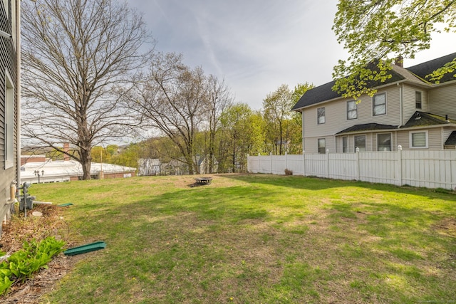 view of yard with a fire pit and fence
