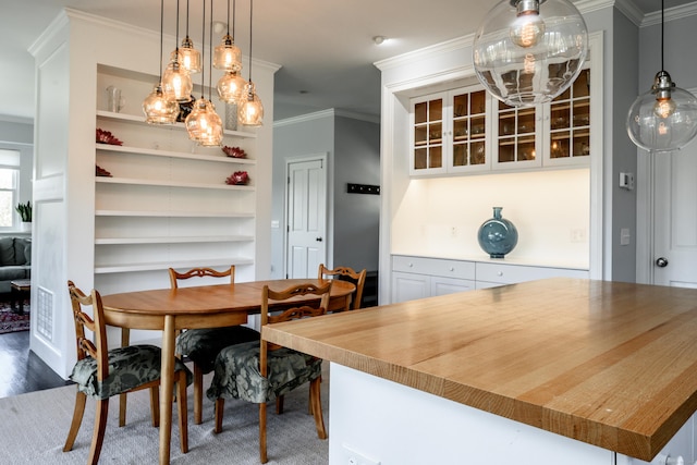 34 Knibloe Hill Rd, Sharon, CT 06069 - dining area featuring crown molding, built in features, and wood finished floors
