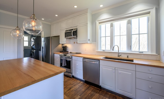 34 Knibloe Hill Rd, Sharon, CT 06069 - kitchen featuring butcher block countertops, stacked washer and dryer, a sink, and stainless steel appliances