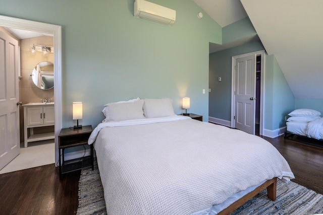 34 Knibloe Hill Rd, Sharon, CT 06069 - bedroom with baseboards, ensuite bathroom, wood finished floors, lofted ceiling, and a wall mounted AC