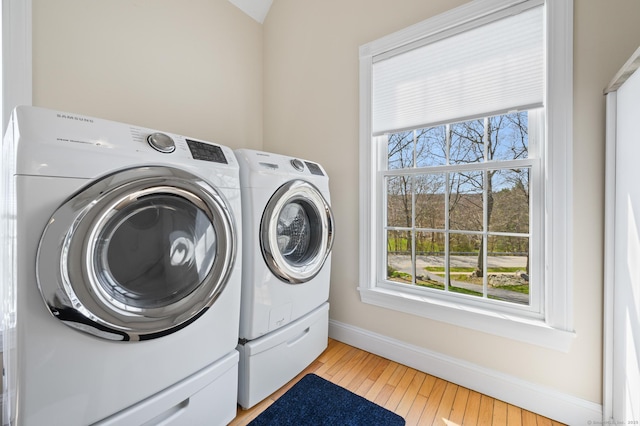 laundry room with separate washer and dryer, plenty of natural light, and laundry area