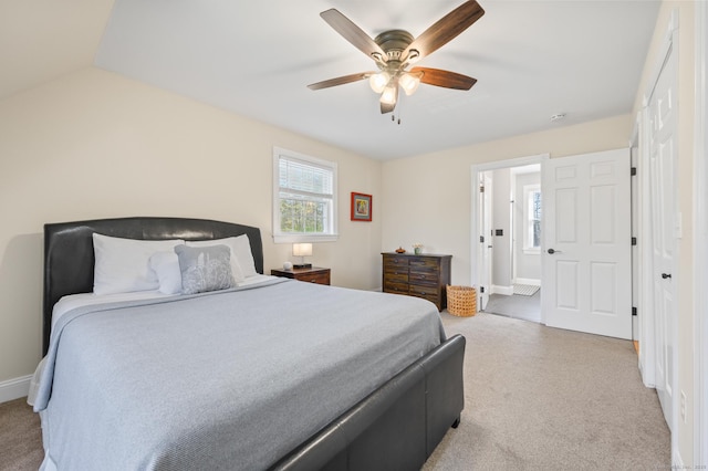 bedroom featuring baseboards, multiple windows, ceiling fan, and light colored carpet