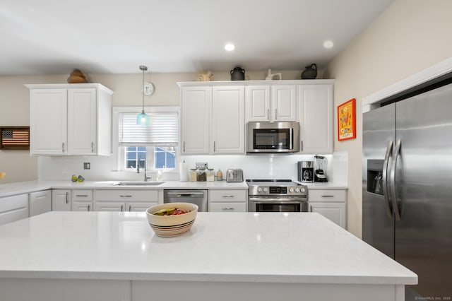 kitchen featuring a sink, white cabinetry, tasteful backsplash, and stainless steel appliances
