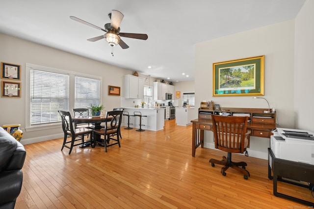 office space featuring a ceiling fan, baseboards, recessed lighting, and light wood-type flooring