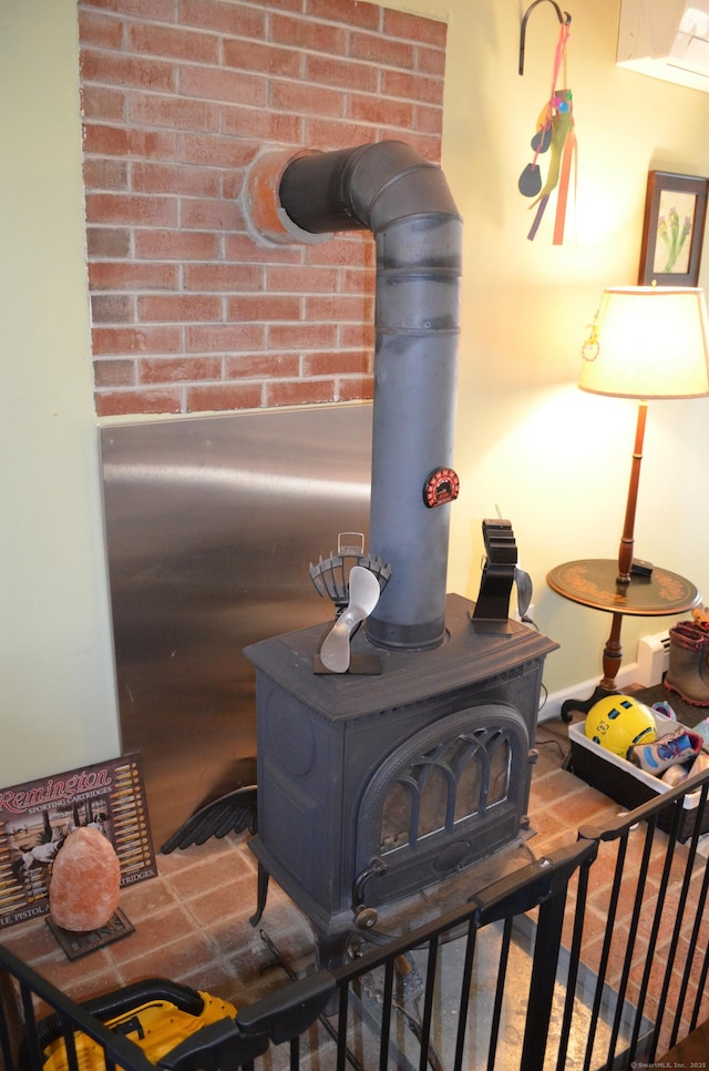 interior details with a wood stove and wood finished floors