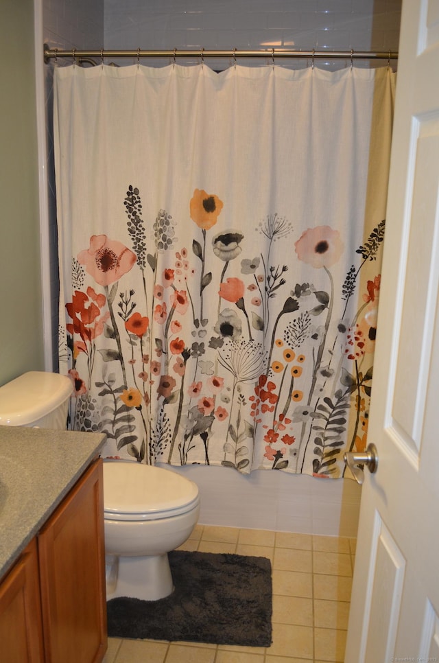 full bathroom featuring toilet, tile patterned floors, shower / bath combo, and vanity