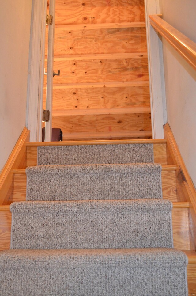 stairs featuring baseboards and wood finished floors