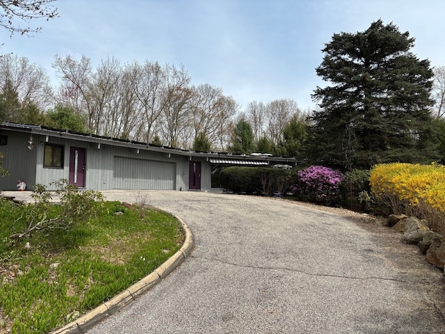 exterior space featuring aphalt driveway and a garage