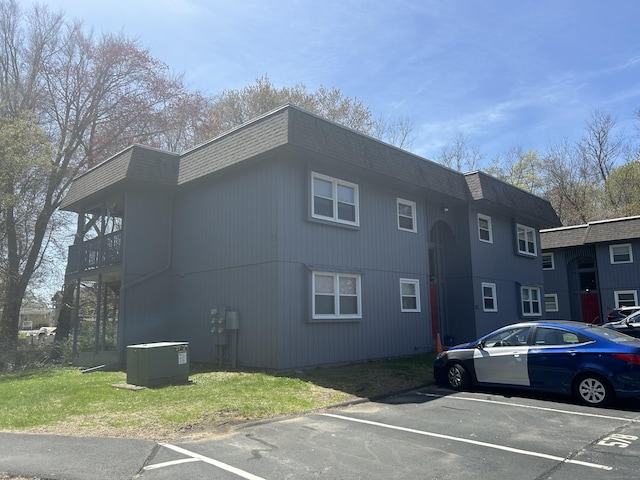 55 Virginia Ave Apt C, Groton, CT 06340 - view of side of property with uncovered parking, cooling unit, mansard roof, and a yard