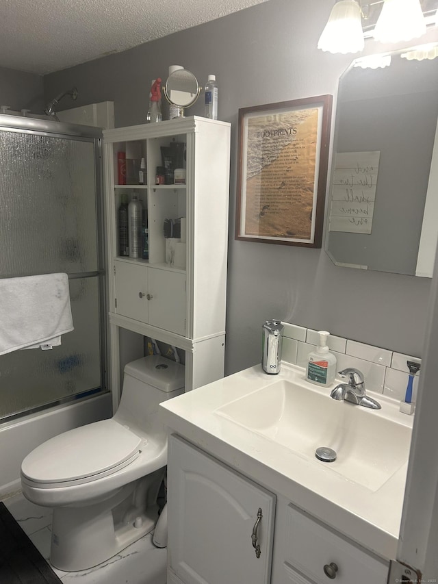 55 Virginia Ave Apt C, Groton, CT 06340 - full bath featuring vanity, shower / bath combination with glass door, toilet, and a textured ceiling