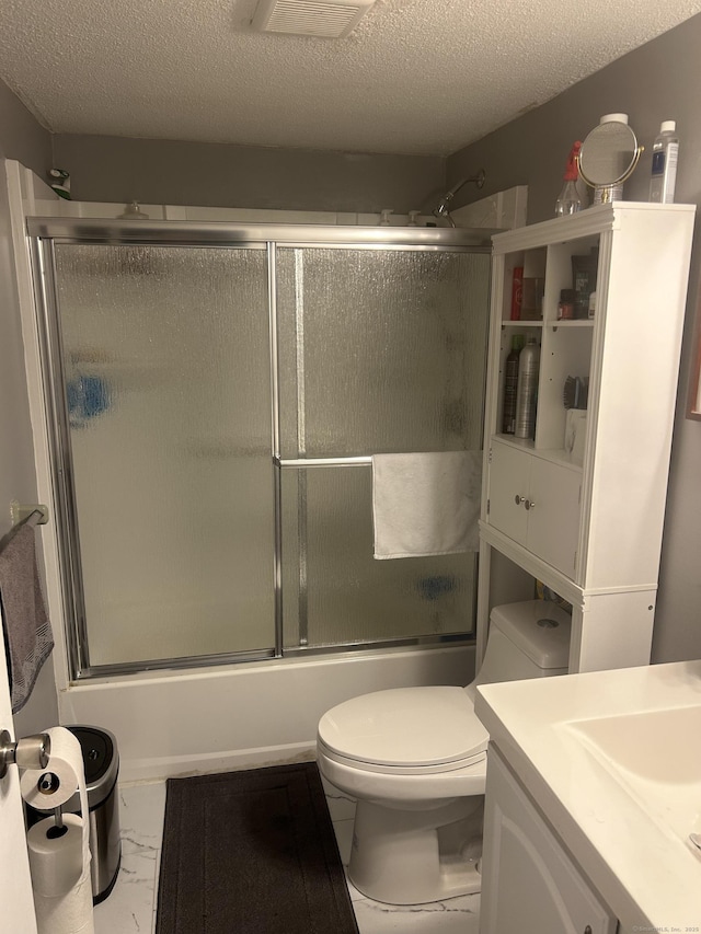 55 Virginia Ave Apt C, Groton, CT 06340 - bathroom with marble finish flooring, a textured ceiling, bath / shower combo with glass door, toilet, and vanity