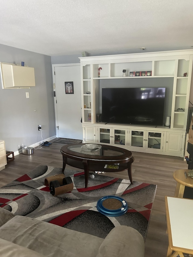 55 Virginia Ave Apt C, Groton, CT 06340 - living area with wood finished floors, a textured ceiling, and baseboards