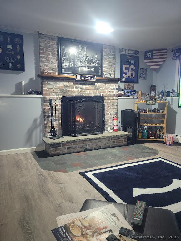 living room with wood finished floors and a fireplace