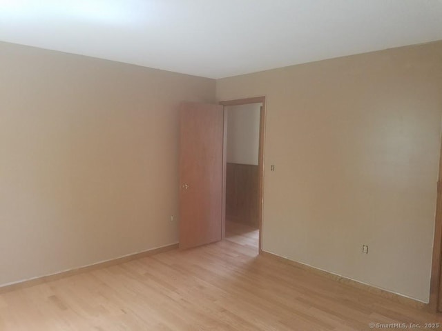 unfurnished room with light wood-style floors