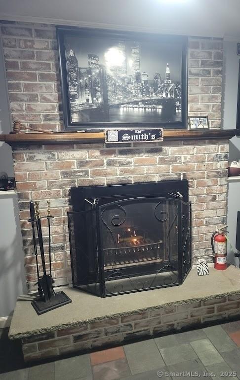 room details with a brick fireplace and a fire extinguisher