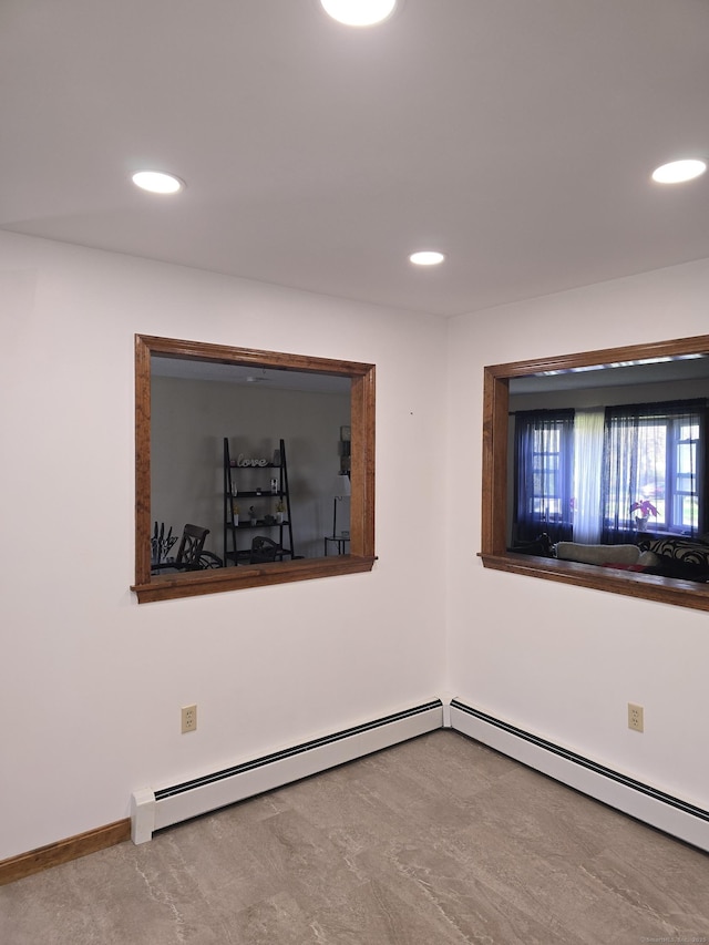 unfurnished room featuring recessed lighting, baseboards, and a baseboard heating unit