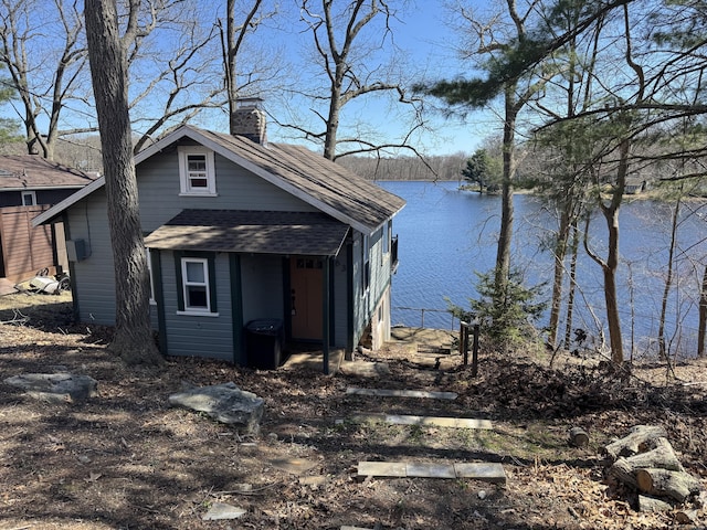 63 W Shore Dr, Haddam, CT 06441 - view of side of property with a chimney, a water view, roof with shingles, and an outbuilding