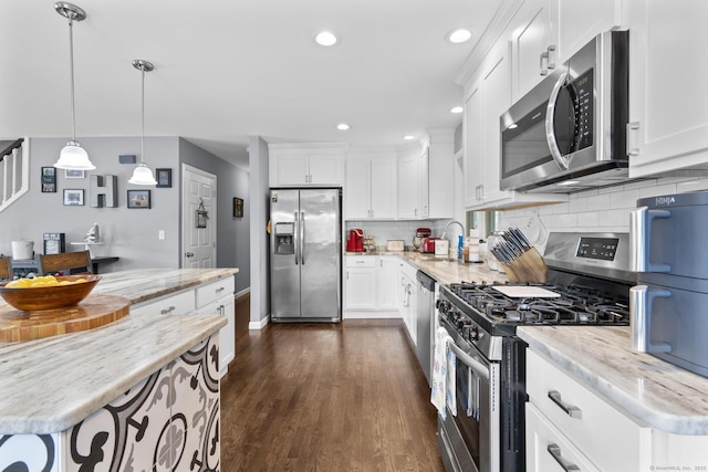 117 Mansfield Grove Rd, East Haven, CT 06512 - kitchen featuring stainless steel appliances, white cabinets, decorative backsplash, dark wood-style floors, and recessed lighting