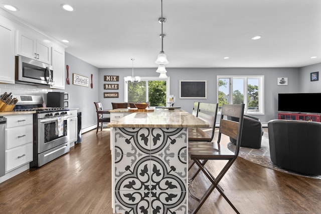 117 Mansfield Grove Rd, East Haven, CT 06512 - kitchen featuring appliances with stainless steel finishes, plenty of natural light, dark wood-style floors, recessed lighting, and white cabinetry
