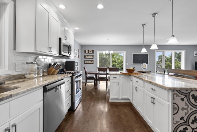 117 Mansfield Grove Rd, East Haven, CT 06512 - kitchen with appliances with stainless steel finishes, dark wood finished floors, recessed lighting, white cabinets, and backsplash