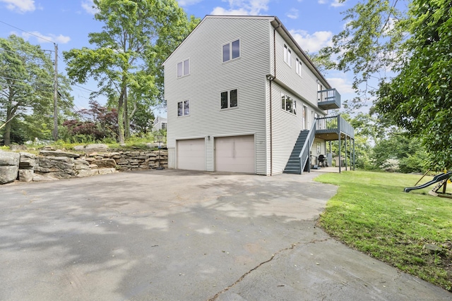 117 Mansfield Grove Rd, East Haven, CT 06512 - view of side of property with an attached garage, a lawn, driveway, and a deck