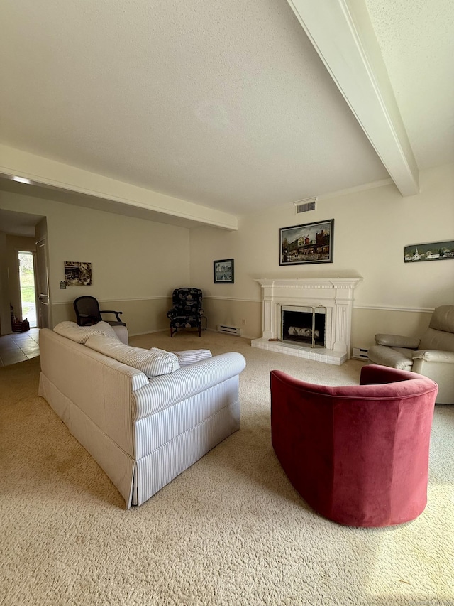 carpeted living room featuring a fireplace with raised hearth and beamed ceiling