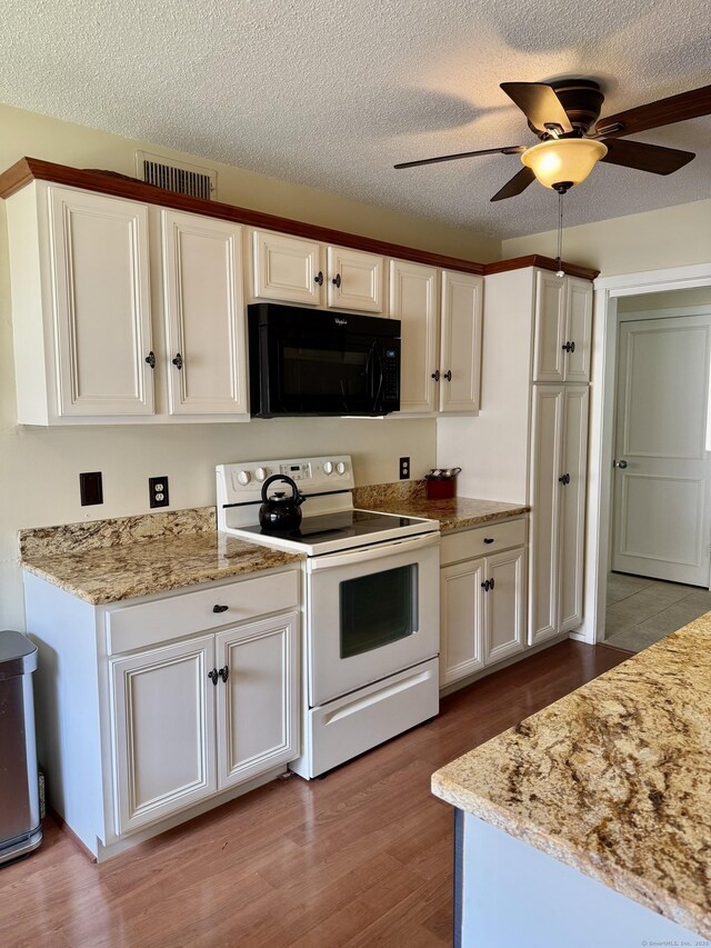 336 Heritage Vlg Unit B, Southbury, CT 06488 - kitchen with black microwave, white electric range, wood finished floors, white cabinetry, and ceiling fan