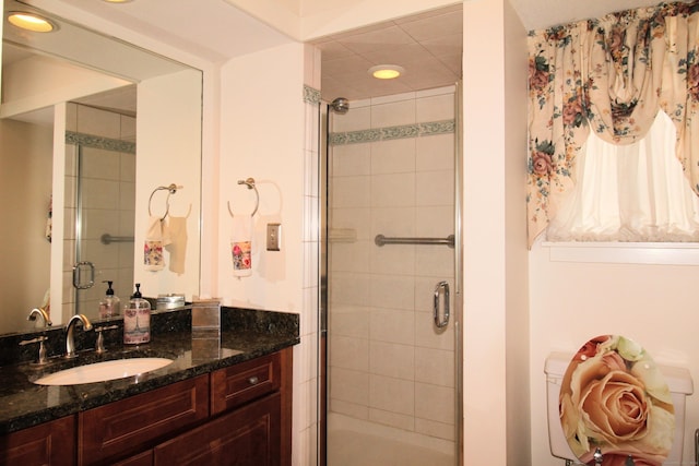 bathroom with a shower stall, vanity, and recessed lighting