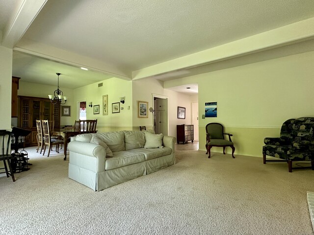 336 Heritage Vlg Unit B, Southbury, CT 06488 - living room featuring a chandelier, carpet, and beamed ceiling
