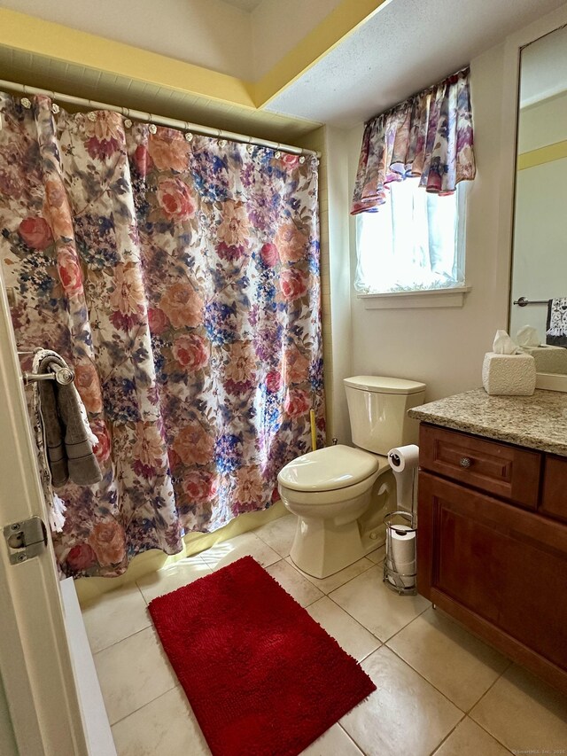 336 Heritage Vlg Unit B, Southbury, CT 06488 - bathroom with toilet, vanity, tile patterned flooring, and curtained shower