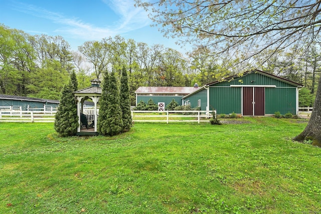 view of yard with a gazebo, an outbuilding, and an outdoor structure